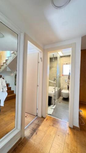 a hallway with a bathroom with a toilet and a mirror at TEL AVIV -yafo in Tel Aviv