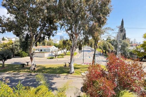 a view of a park with trees and a church at TEL AVIV -yafo in Tel Aviv