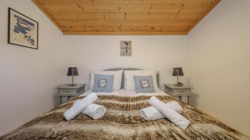 a bedroom with a large bed with two night stands at Apartment Jochberger Tor by ONE-Villas in Jochberg