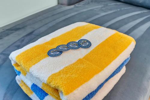 a towel with three coins on top of it at 6-Min Walk to Asbury Park & OG Main St - Updated & Cozy Apartment in Historic Ocean Grove - Fire Pit & Patio - Fast Wi-Fi in Ocean Grove