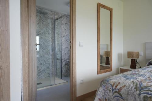 a bedroom with a glass door leading to a bed at La casina de Tomás in Colunga