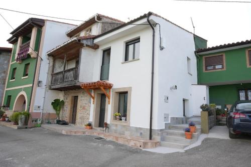 a white house with green and white buildings at La casina de Tomás in Colunga