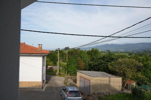a car parked in the driveway of a house at La casina de Tomás in Colunga
