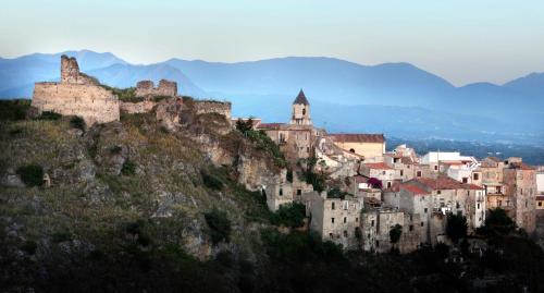 a town on top of a mountain with buildings at B&B Civico 64 Scalea in Scalea