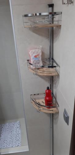 a shelf in a refrigerator with a red kettle on it at P & M Studio in Kavala