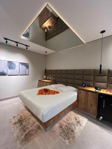 a bedroom with a large bed in a room with rugs at Status Motel Ourinhos in Ourinhos