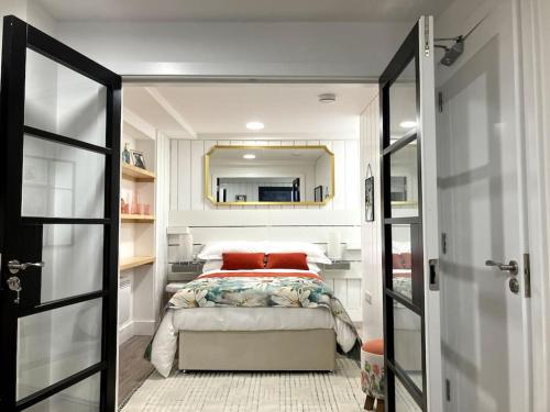a small bedroom with a bed and a mirror at Luxury Town Centre Apartment in Killorglin