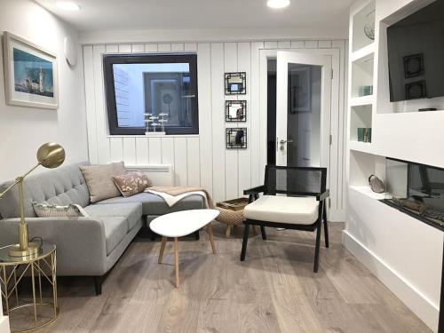 a living room with a couch and a table at Luxury Town Centre Apartment in Killorglin