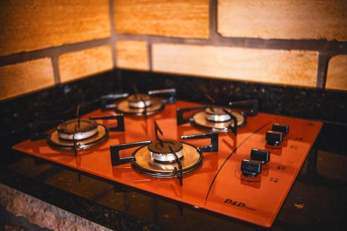 a group of burners on a stove in a room at Pousada Equilíbrio dos Canyons in Praia Grande