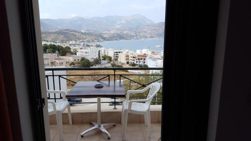 a view of a balcony with a table and chairs at Giota's Studio in Karpathos Town