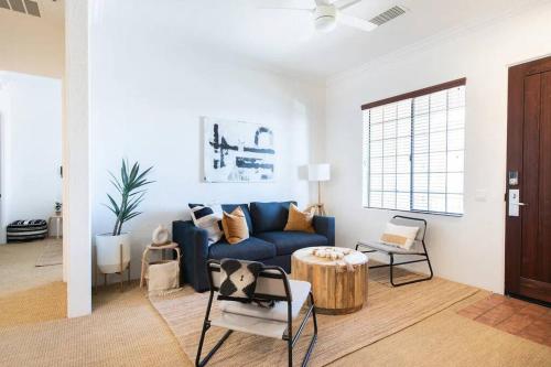 a living room with a blue couch and a table at The Monarch - Chic 1BR Pools and Views in Old Town La Quinta in La Quinta