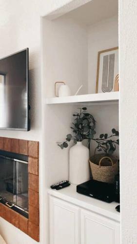 a kitchen with white cabinets and a microwave at The Monarch - Chic 1BR Pools and Views in Old Town La Quinta in La Quinta