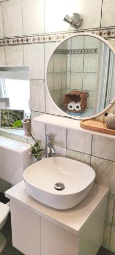 a bathroom with a white sink and a mirror at Apartment BoNo in Šmrika