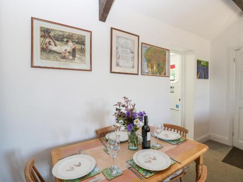 a dining room table with plates and wine glasses at Dale View Cottage in Hexham