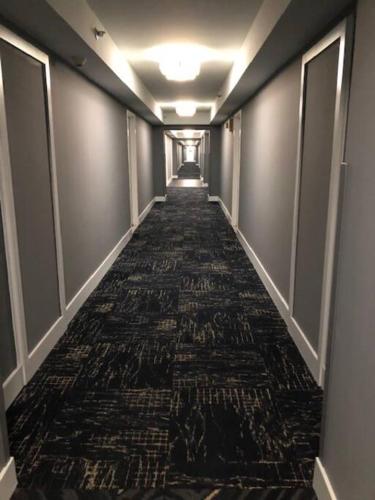 a long hallway with a carpeted floor in a building at Ocean front 2 Bedroom and 2 Bathroom apartment at The Alexander Resort in Miami Beach