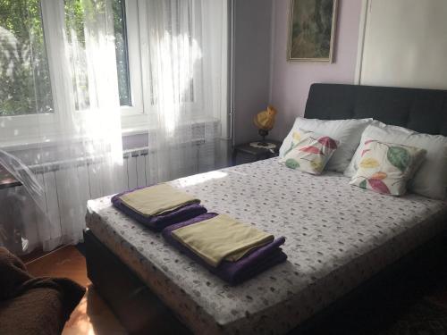 a bed with two towels on it in a bedroom at Zeleno i plavo in Kraljevica