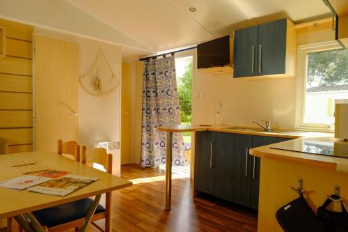 a kitchen with a table and a counter top at Atlantic Shell Bungalow in Pataias