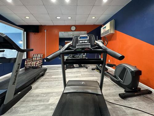 a gym with a treadmill and a computer in a room at BayVue Hotel, Resort & Suites in Ocean Shores