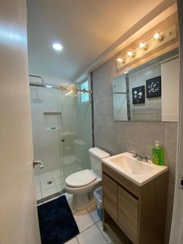 a bathroom with a toilet and a sink and a shower at Marina del Sol Resort - beautiful 2 bdrm Sleeps 8 -Ocean front in Mazatlán