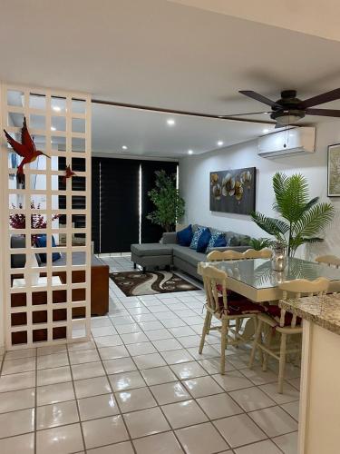 a living room with a couch and a table at Marina del Sol Resort - beautiful 2 bdrm Sleeps 8 -Ocean front in Mazatlán