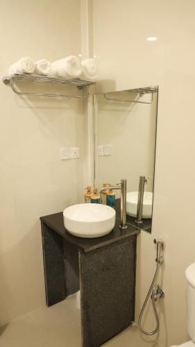 a bathroom with a sink and a mirror at Shifa Lodge Maldives in Feridhoo