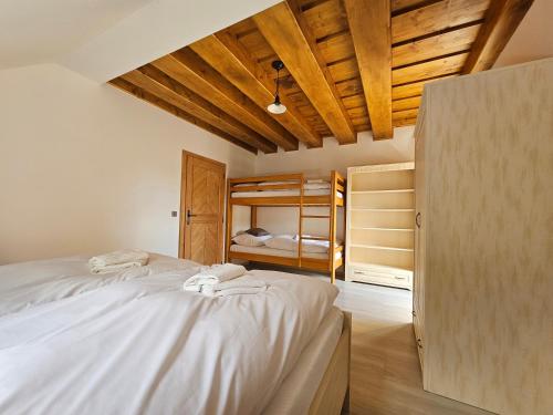 a bedroom with two beds and a bunk bed at Apartmány Jezerné in Velké Karlovice