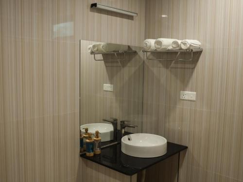 a bathroom with a sink and a mirror at Shifa Lodge Maldives in Feridhoo