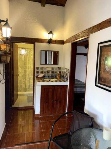 a kitchen with a sink and a table in a room at Cabaña 1111 in Valle de Bravo