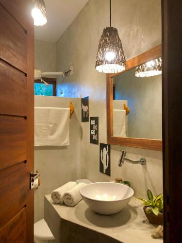 a bathroom with a bowl sink and a mirror at Villa Piauí in Barra Grande