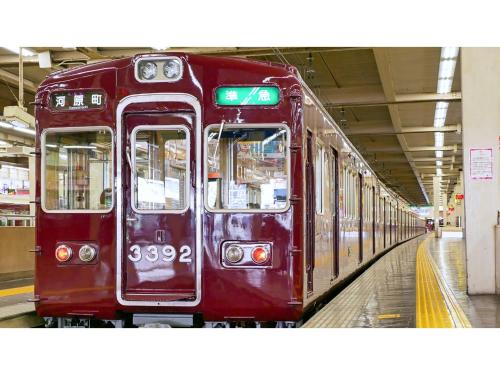 a red train is parked in a train station at Takatsuki W&M Hotel - Vacation STAY 48527v in Takatuki