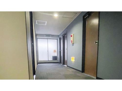 a hallway of an office building with a hallway at Takatsuki W&M Hotel - Vacation STAY 48538v in Takatuki