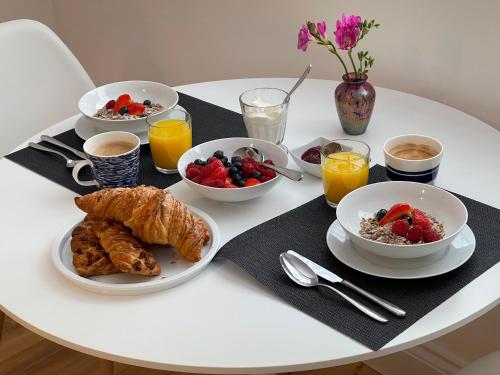 a white table with breakfast foods and drinks on it at Guest Room with Parking Near St Ives & Penzance in Penzance