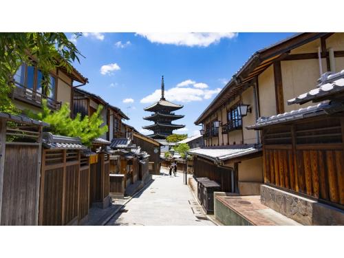 an alley with buildings and a pagoda in the background at Takatsuki W&M Hotel - Vacation STAY 48538v in Takatuki