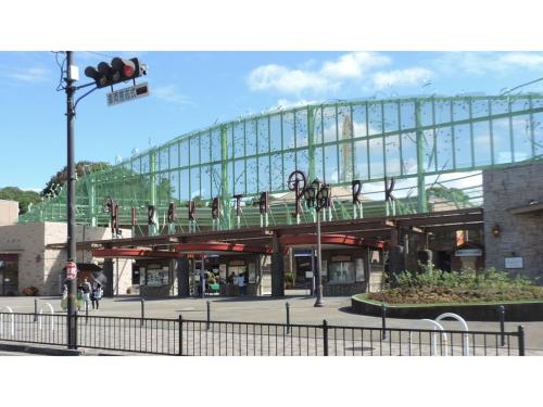 a building with a bridge with people on it at Takatsuki W&M Hotel - Vacation STAY 48538v in Takatuki