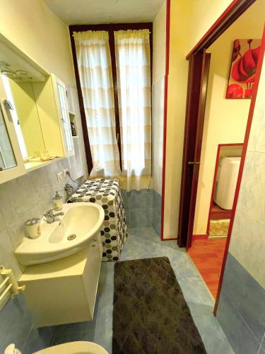 a bathroom with a sink and a bed in a room at A.R.Inter.3 in Brescia