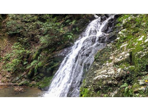 a waterfall on the side of a cliff at Takatsuki W&M Hotel - Vacation STAY 48549v in Takatuki