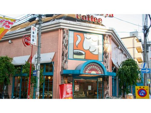 a building with a coffee sign on the side of it at Takatsuki W&M Hotel - Vacation STAY 48546v in Takatuki