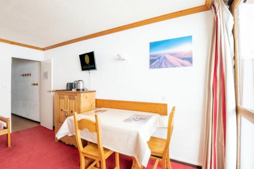 une salle à manger avec une table et des chaises dans l'établissement Résidence Le France - Studio 3 pers - LE FRANCE - PLAGNE CENTRE MAE-9164, à Aime La Plagne