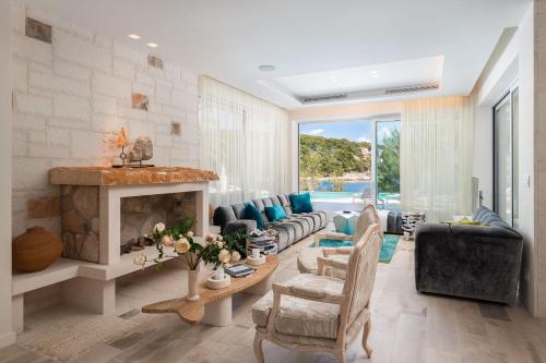 a living room with a couch and a fireplace at Villa Mila in Selca