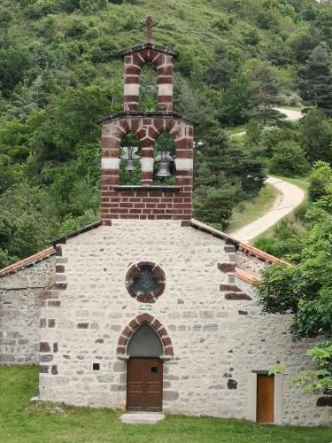 an old stone church with a bell tower on a hill at Maison confortable à Vergezac avec terrasse in Vergezac