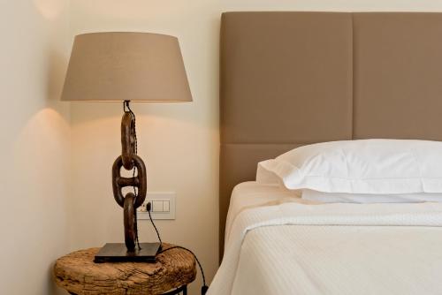 a lamp sitting on a table next to a bed at Villa Mila in Selca