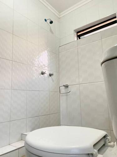 a white bathroom with a toilet and a shower at SummerPlace Studio Apartments with Kitchenette in Modimolle