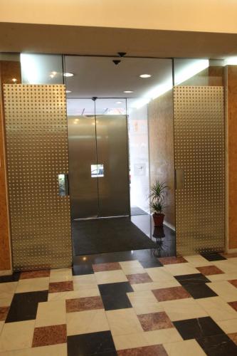 a lobby with a glass walled shower in a building at Hotel Central in Timişoara