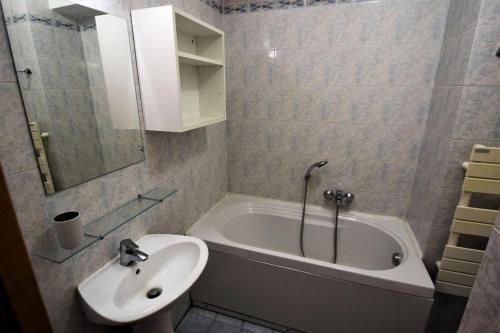 une salle de bain avec un lavabo et une baignoire et un lavabo dans l'établissement Résidence Lodges Des Alpages - 3 Pièces 6 pers - LES LODGES DES ALPAGES - PLAGNE SOLEIL MAE-4284, à Aime La Plagne