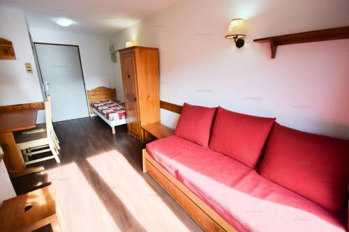 - un salon avec un canapé rouge dans l'établissement Résidence Le Cervin - 2 pièces 4 pers- WIFI- Le CERVIN- PLAGNE SOLEIL MAE-7724, à Aime La Plagne