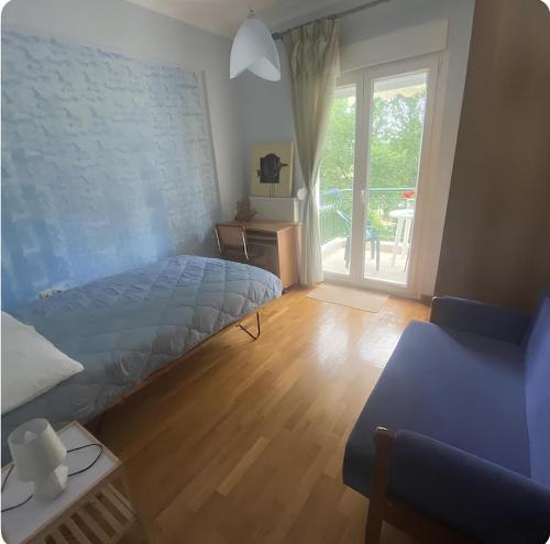 a bedroom with a bed and a sliding glass door at Στη γοητεία του Ολύμπου in Litochoro