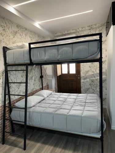a bedroom with a bunk bed in a room at Vellosol in Vigo