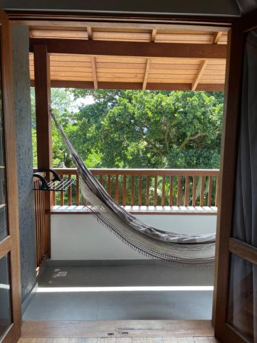 a hammock on the balcony of a house at Refúgio 755 in Florianópolis