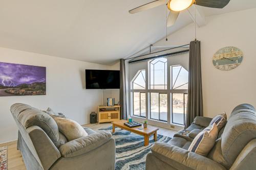 a living room with two couches and a large window at 5 Mi to River Topock Boating and Off-Roading Oasis! in Topock