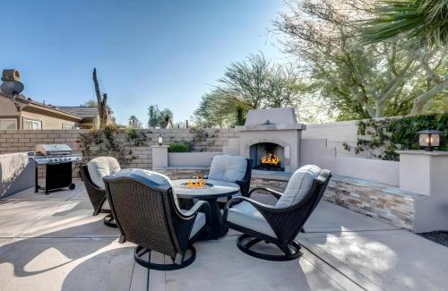 a patio with a table and chairs and a fireplace at Lux Desert Oasis w saltwater pool near Coachella in Indio